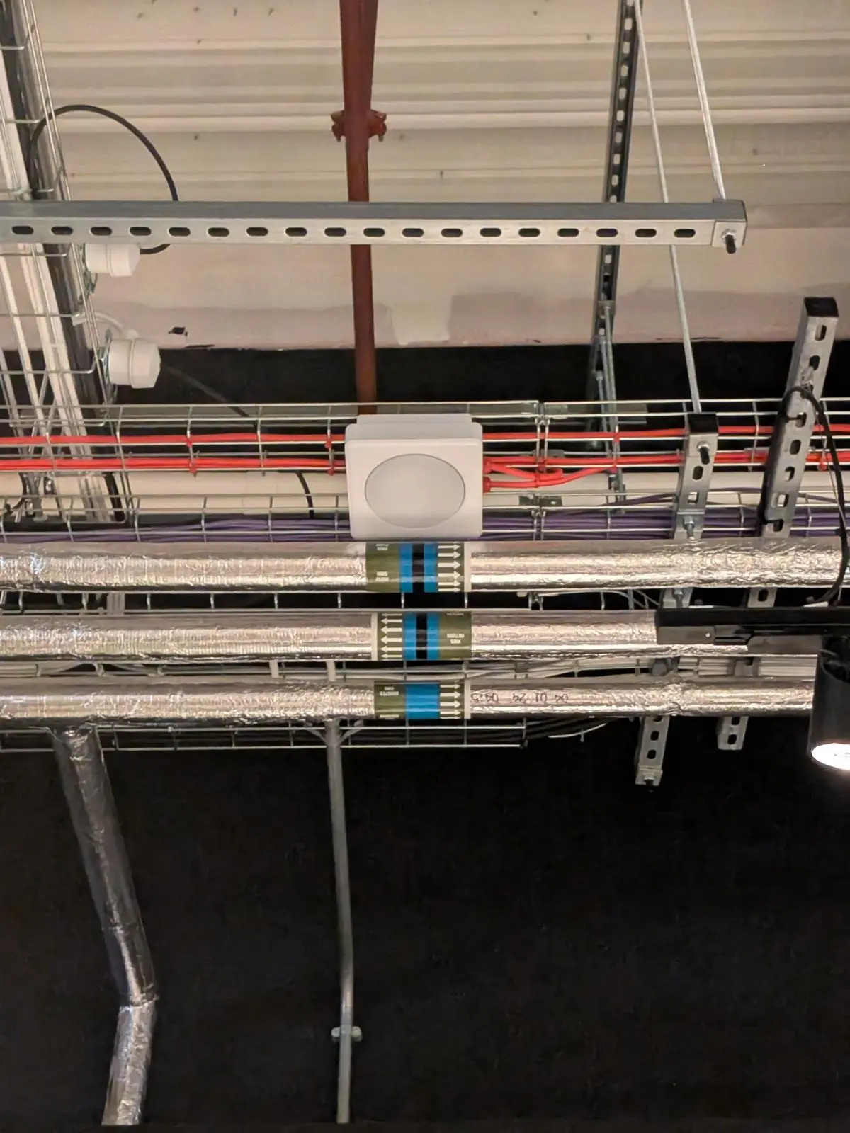 PIPEMARK service markers and flow arrows fitted to insulated pipework in a plant installation